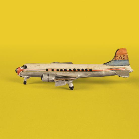A tiny model of a Douglas DC-4 that was made from household items like matchsticks, cardboard, and chewing gum.