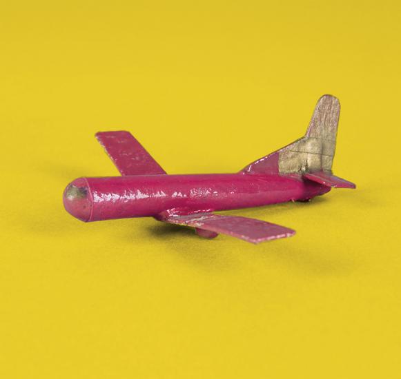 A tiny model of a C-46 Commando that was made from household items like matchsticks, cardboard, and chewing gum.