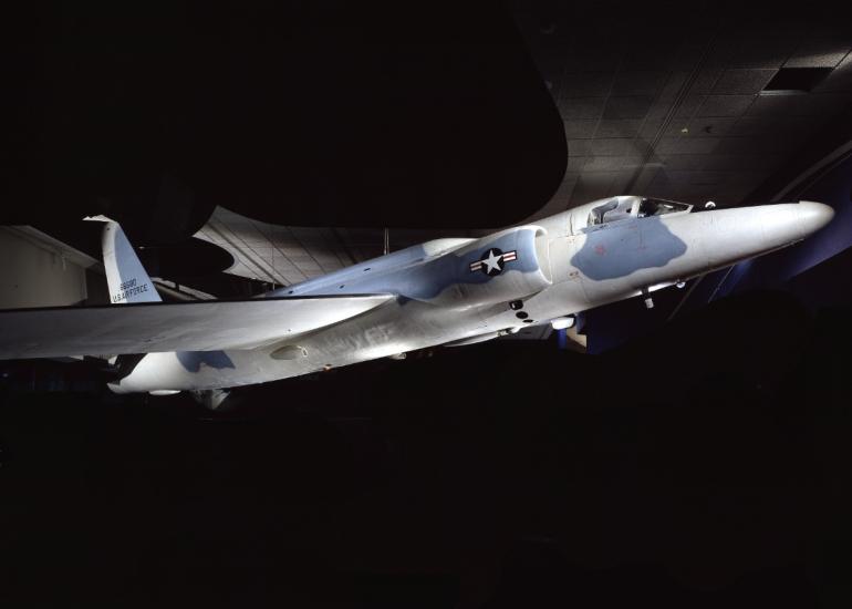 A plane with blue and white camouflage and a U.S. Air Force logo. 