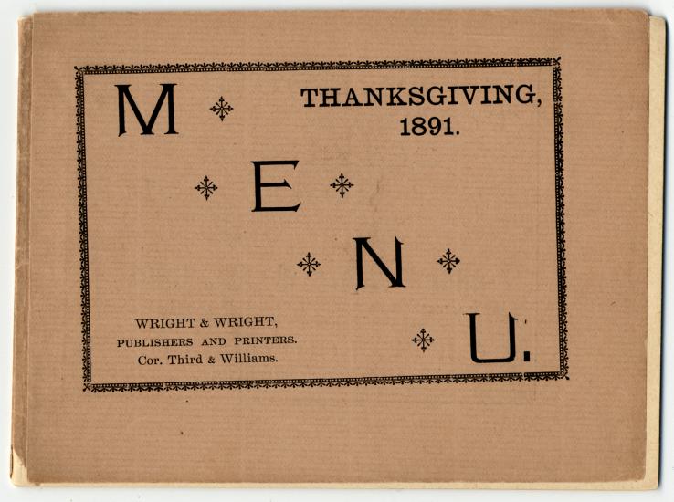 A orange paper printed with the word menu going down diagonally left-to-right. The top right hand corner says Thanksgiving, 1891. The Wright & Wright logo is in the bottom lefthand corner.