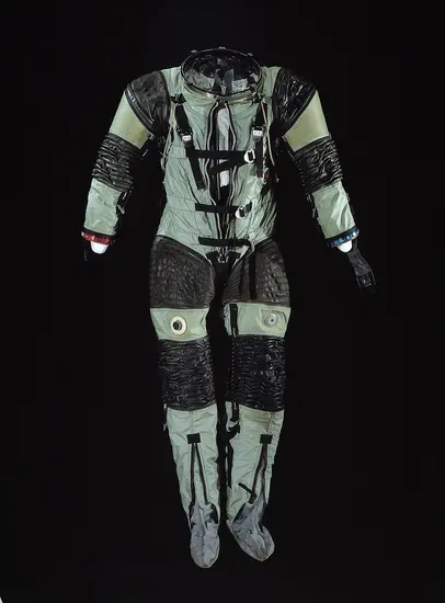 A pale green and black striped suit posed against a black background. 