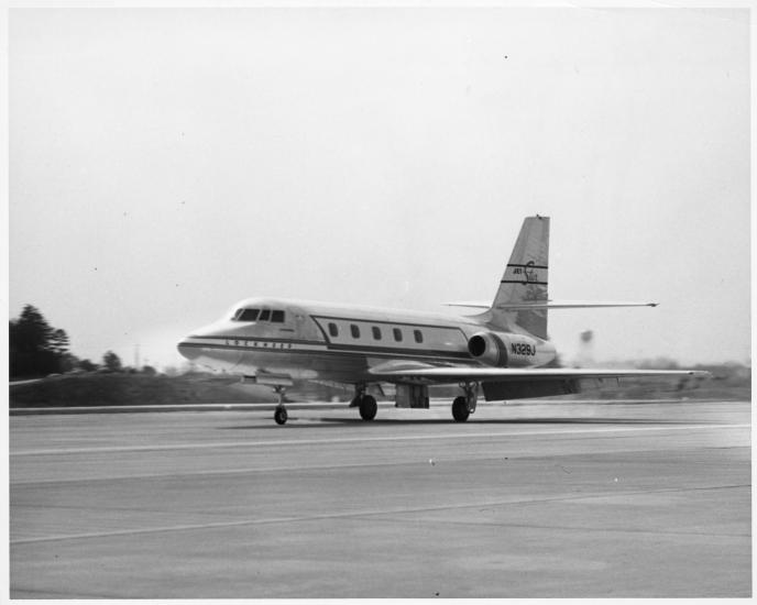 A mid-sized jet airplane landing on the runway.