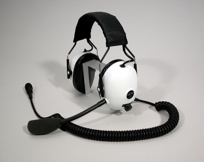 Headphones with white earmuffs and a microphone.