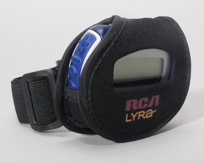 A small circular speaker, which looks similar to a digital watch, in a pouch with a strap.