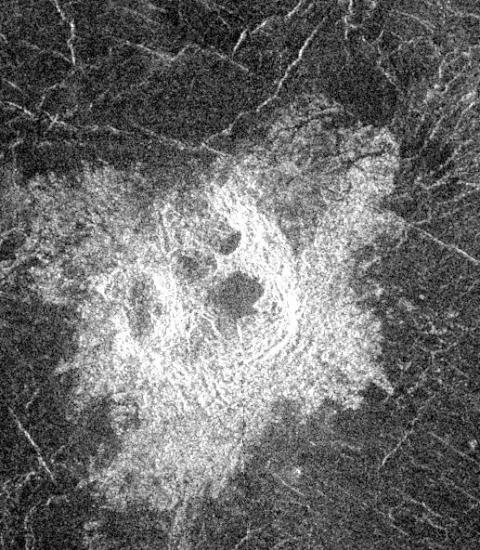 A black and white image with a crater in the center. 