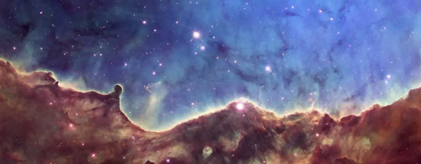 What appears to be a wavy purple cloud with spots of light, in front of a blue field with spots of light in it. 