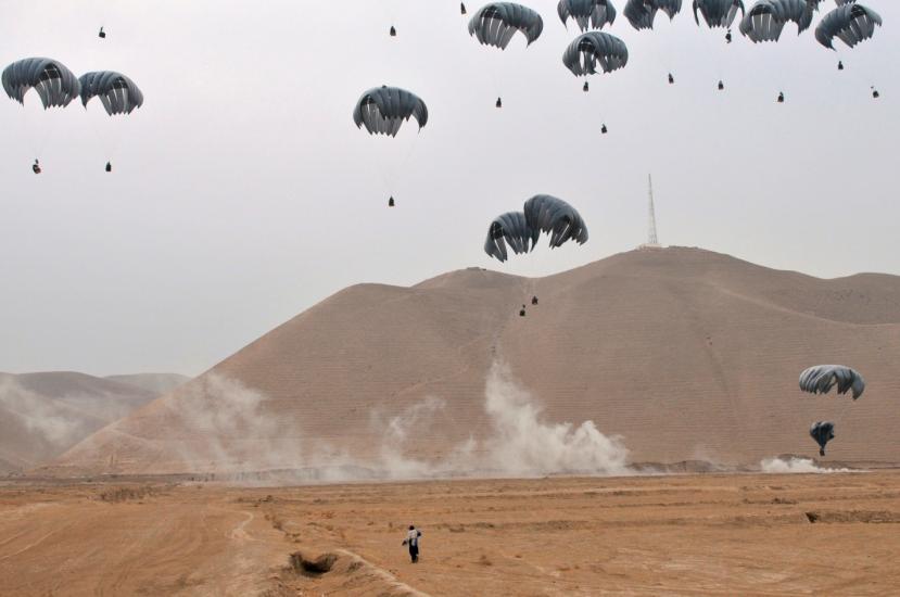 A number of packages drift down by parachute. 