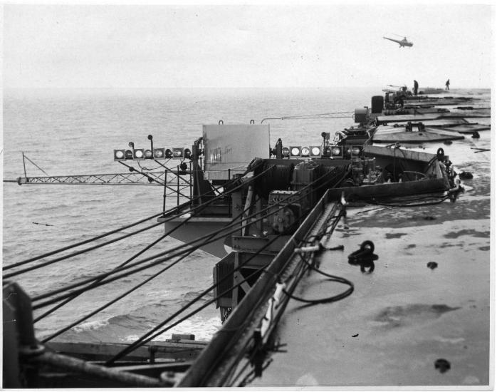 Black and white image of a mirror landing system (MLS) seen on the edge of an aircraft carrier