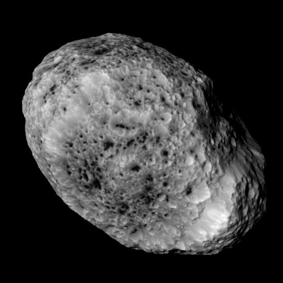 An oval shaped asteroid covered in crater marks.