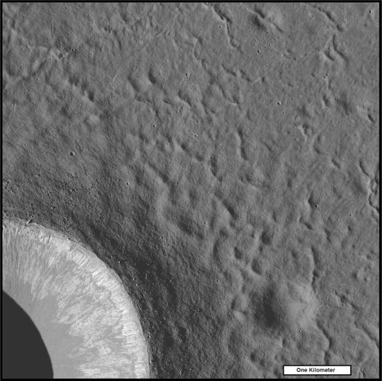 Small ridges surround the outside of a crater on the Moon.