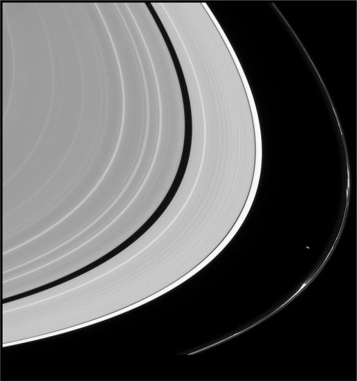 An image in black and white of bands of rings, which take up most of the frame. The outermost visible ring has a large gap between it and the other rings.