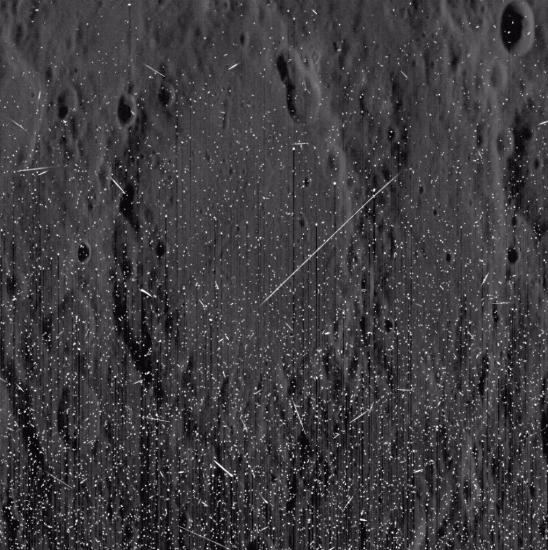 Bright streaks and speckles muddy up an image of Mercury's surface.