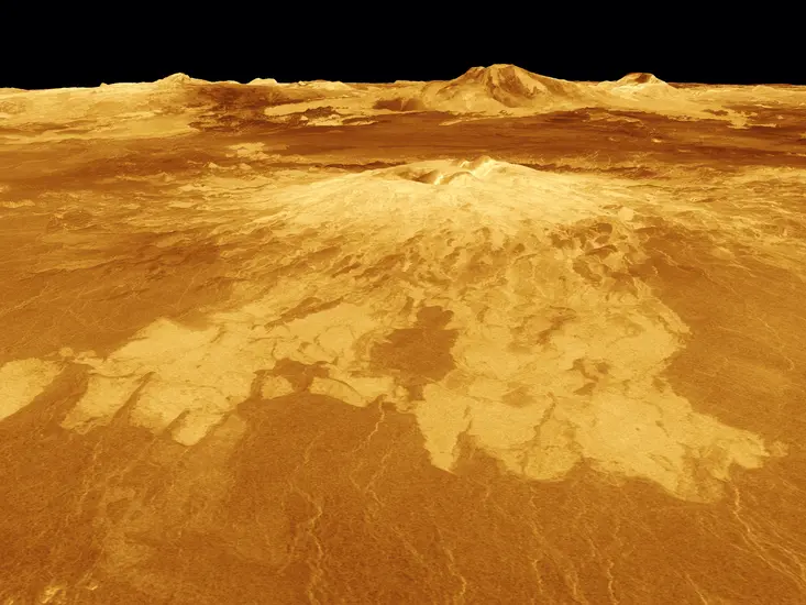 The surface of Venus with Sapas Mons at the center and various ridges in the background.