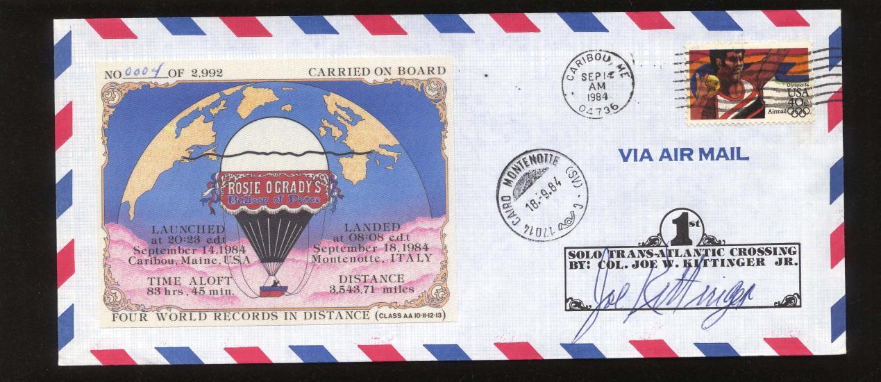 A mail envelope with a USA stamp on it and a postcard with an air balloon attached to it.