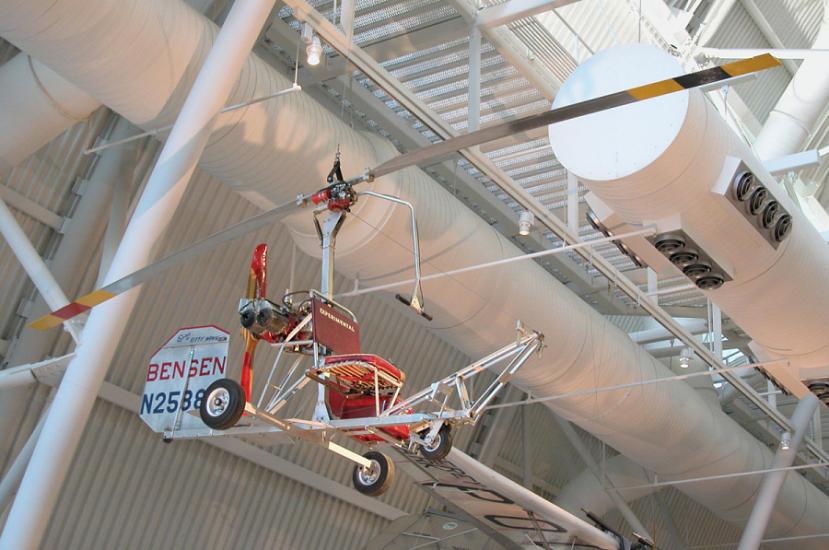 What looks like a seat with a small rudder and with two giant blades suspended above it. 