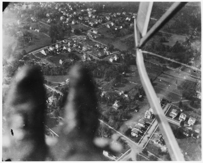 A photo taken looking down at Earth. Blurry boots can be seen in the corner of the frame. 