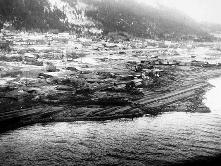 An aerial photo of a small city on the coast that lays mostly in ruin.