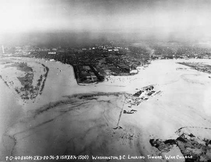 An aerial photo of the coast of the Potomac River, which has overflowed onto the land and covered some structures.