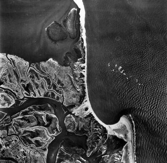 An aerial photograph of swooping coastline.