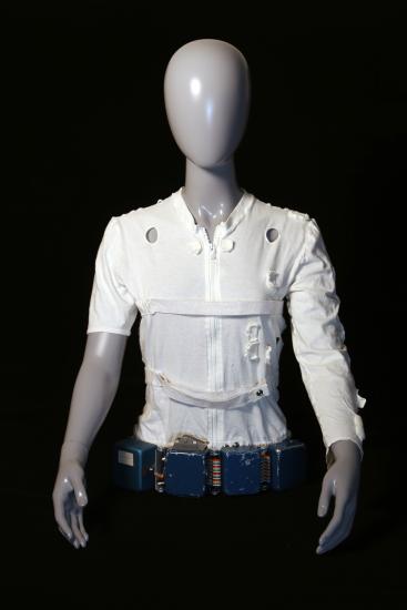 Mannequin wearing a white leotard and belt.