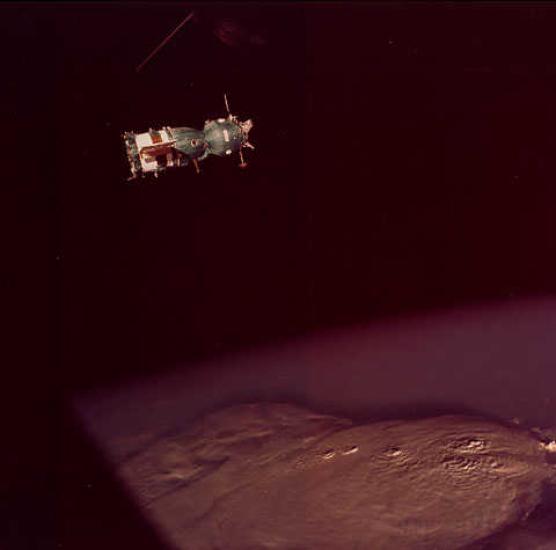 A spacecraft in orbit over a mass of thick clouds.