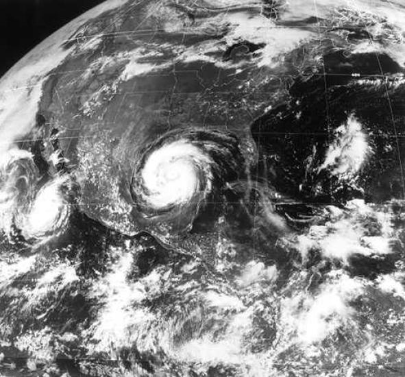 A satellite view of the southeastern part of the United States. A large storm swirls in the Gulf of Mexico.