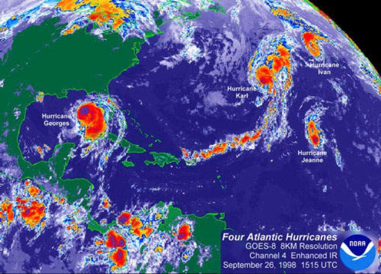 A meteorological satellite image of four hurricanes all within proximity of each other. Georges is the farthest left, near the Gulf of Mexico; followed by Karl, Ivan, and Jeanne to the right, further into the Atlantic Ocean. 