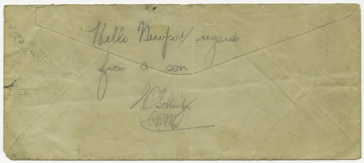 The back of a weathered envelope that has the words "hello newport / regards from a son" and George Schnitzer's signature written on it.