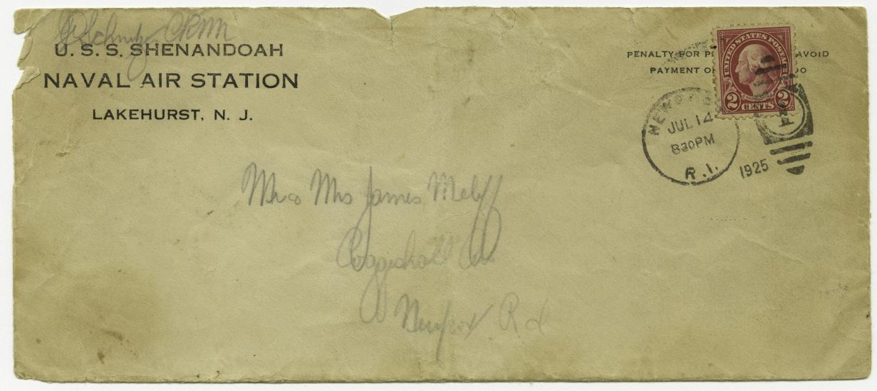 A weathered addressed envelope with a stamp in the upper righthand corner and the words USS Shenandoah, Naval Air Station, Lakehurst, N.J. in the upper lefthand corner.