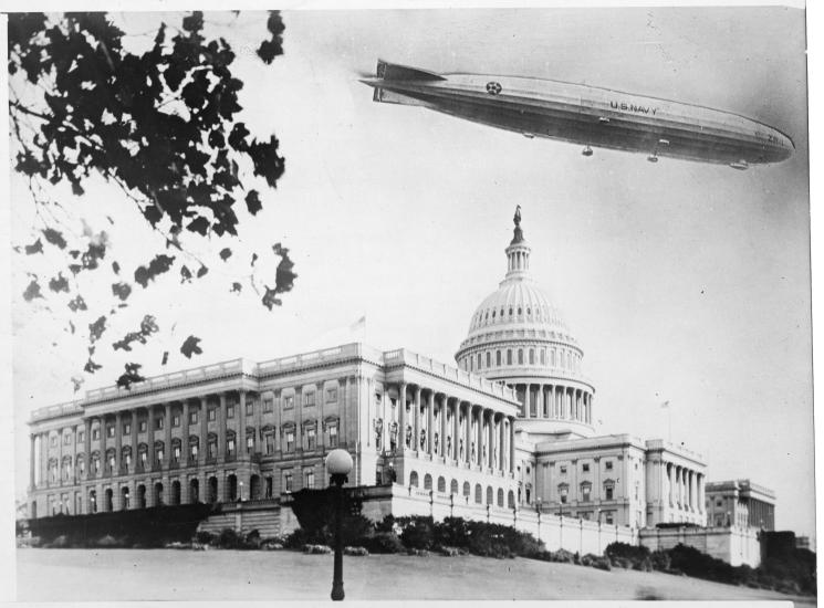 A photo of the USS Shenandoah flying over the Capitol dome.