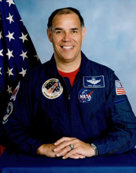 Portrait of Frederick Gregory, a middle aged African American man in a NASA flight suit. 