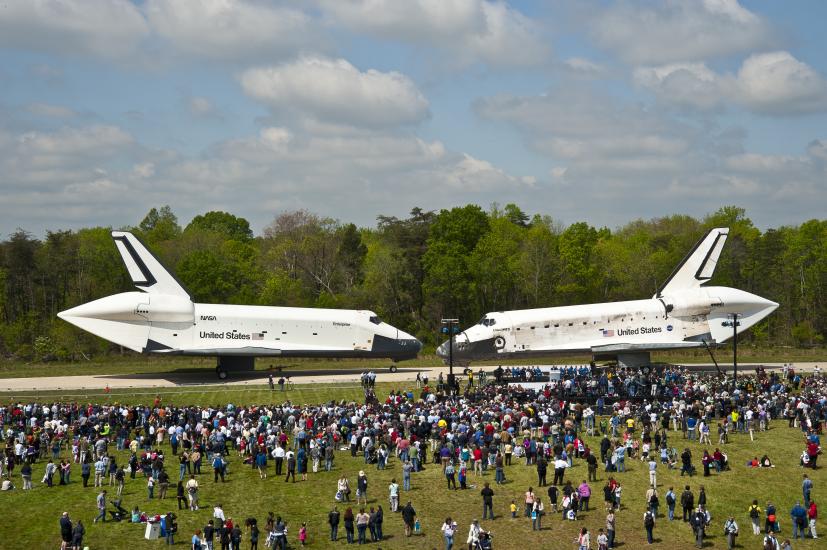 The Space Shuttles Enterprise and Discovery are placed side by side on the tarmac near the Udvar-Hazy Center.