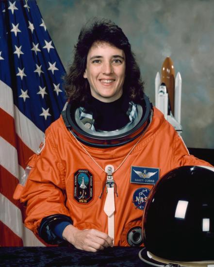 A woman in an orange astronaut suit.