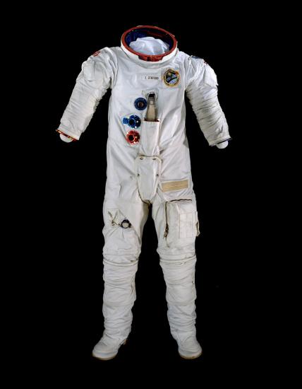 A spacesuit pictured against a black backdrop.