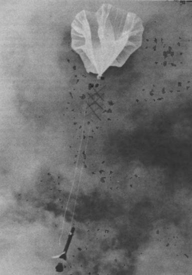 A large balloon attached to a rocket.