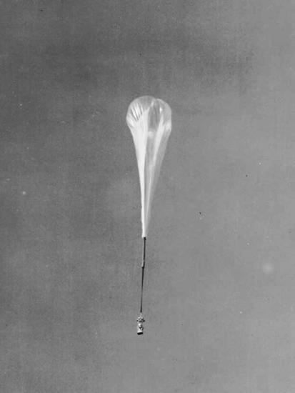 A rocket attached to a hot air balloon.