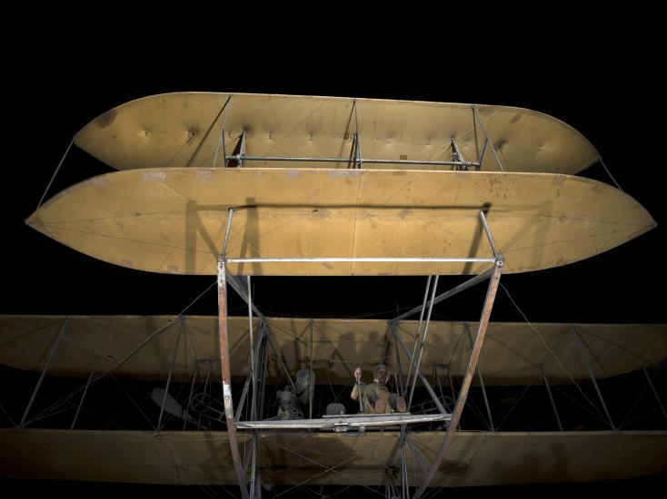 A closeup of a vintage airplane's elevators on a black background.