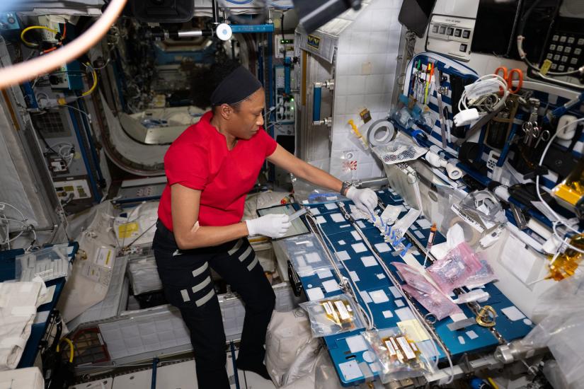 A woman gloating in zero gravity while inside the International Space Station.