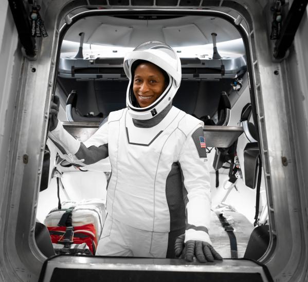 Astronaut Jeanette Epps wearing SpaceX suit while inside a space capsule.