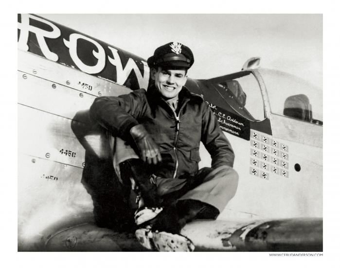 Bud Anderson, a white man, sits on the wing of an airplane.