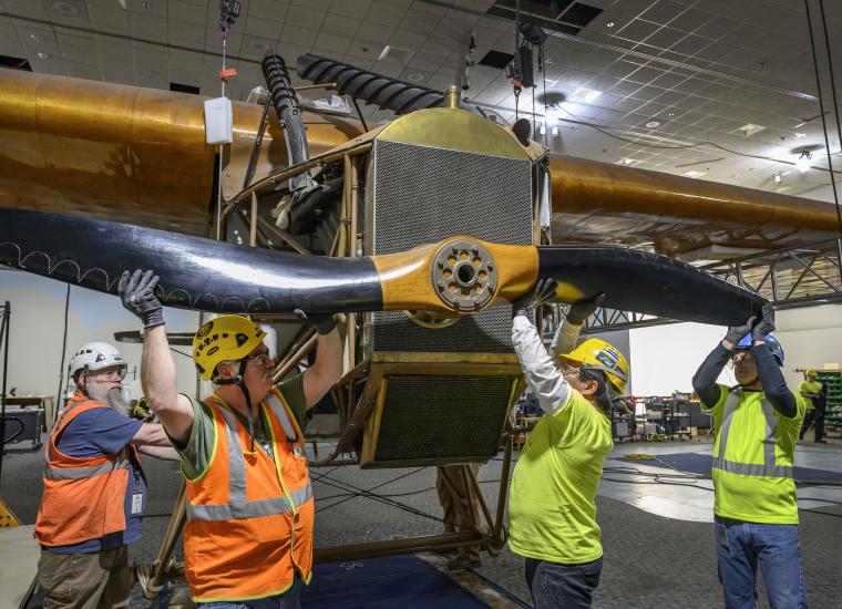 Contractors removing propeller from a plane