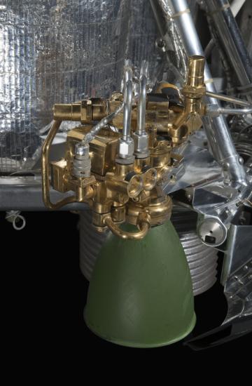 Green painted engine attached to a spacecraft. 