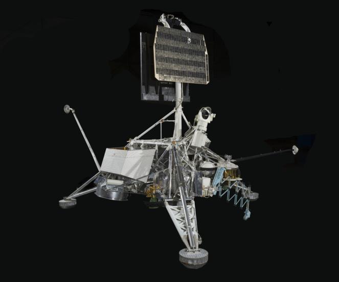 Engineering model with three-legged frame and mixed metals in landing position.