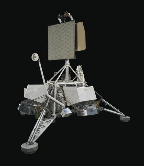 View of a spacecraft with solar panels on top.