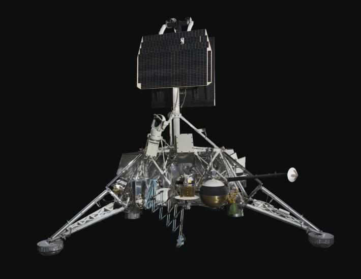 View of a spacecraft with solar panels and a gas tank.