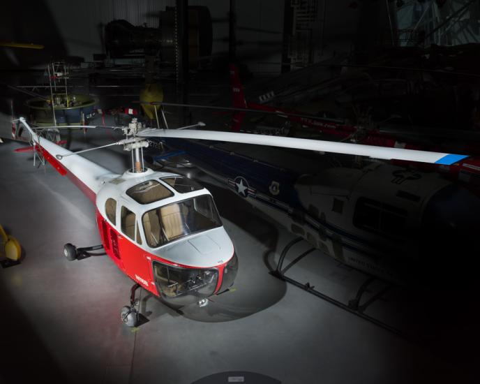 View of a red and white helicopter inside of the museum. 