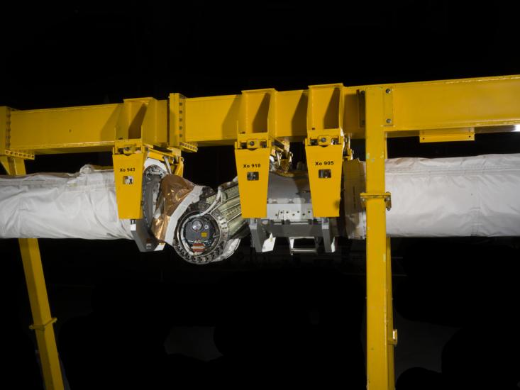 Robotic arm attached to a support beam. 