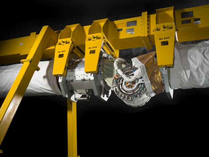 Robotic arm attached to a support beam. 