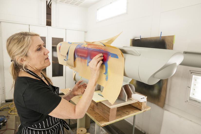 Kim adds red paint to the model's nacelles. 