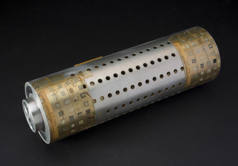 Metal cylindrical tube with small circular holes and tape on edges